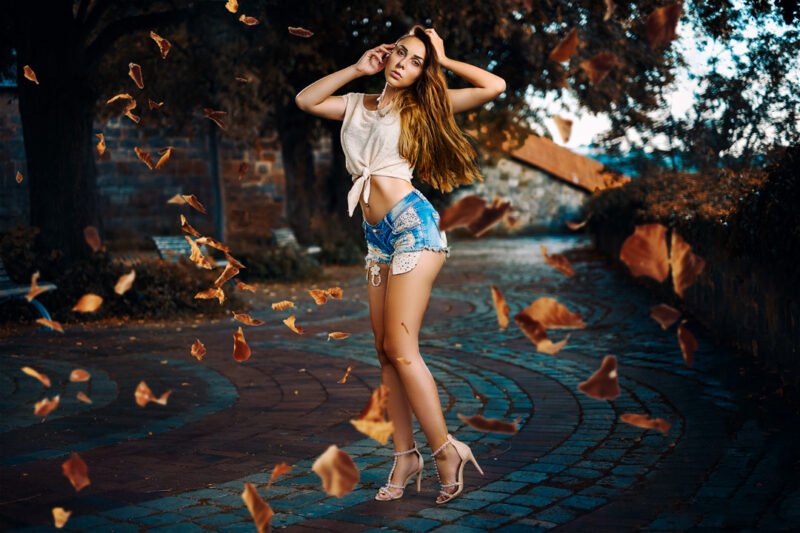 kontrastreiche fotos von model in blauer jeanshort bei herbstwetter draussen