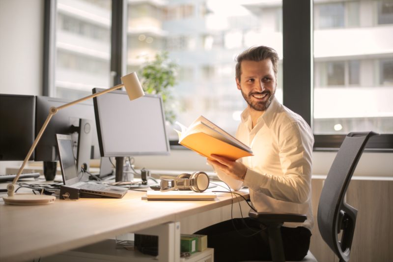 geschaeftsmann sitzt am schreibtisch bei der arbeit